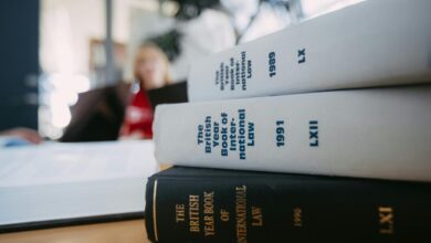 Legal books are stacked on a desk.